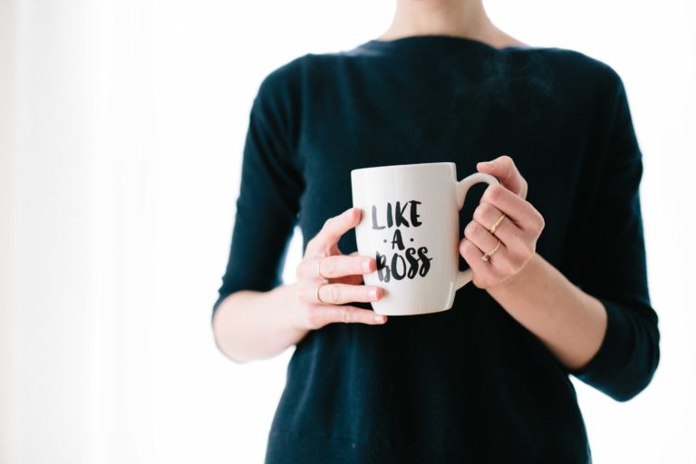 A woman holding a cup saying Like a Boss