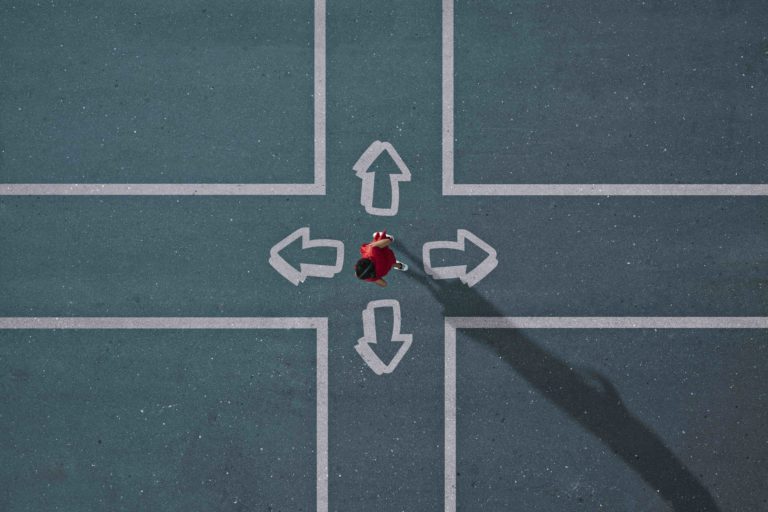 Girl in middle of four arrows choosing the right path